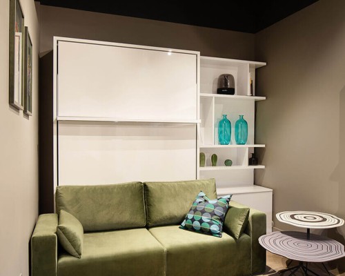 Long Island-themed room featuring the Royal Queen Murphy bed with sectional sofa and bookcase.