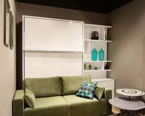 Long Island-themed room featuring the Royal Queen Murphy bed with sectional sofa and bookcase.